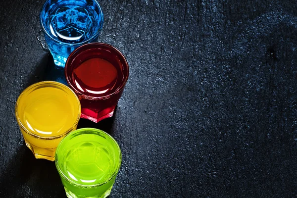 Multi-colored cocktails on a dark background — Stock Fotó