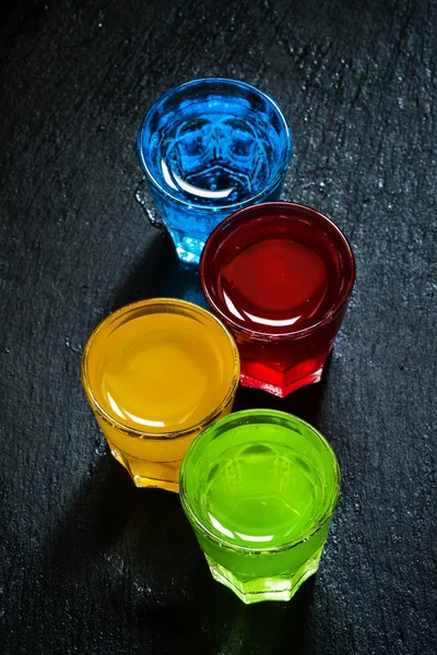 Multi-colored cocktails on a dark background — Stock Fotó