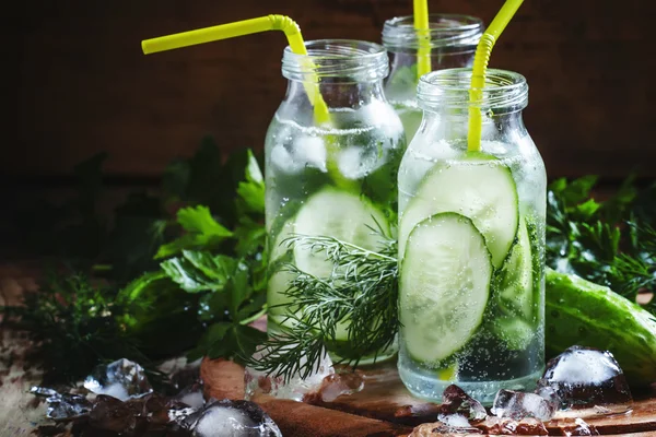 Refreshing cold drink of cucumber and herbs in glass bottles — 图库照片