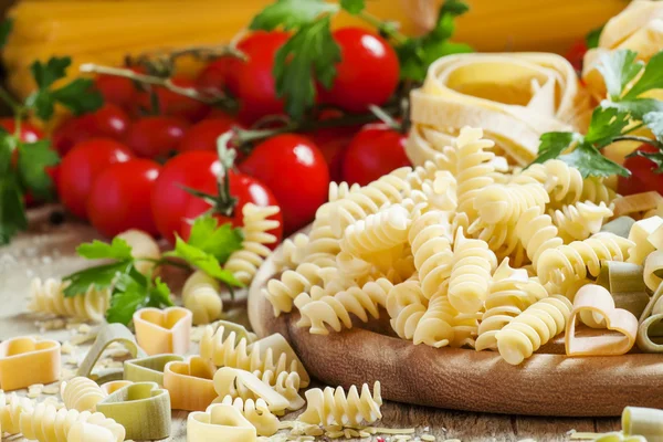 Italian food: pasta spiraline, herbs, tomatoes — Stockfoto