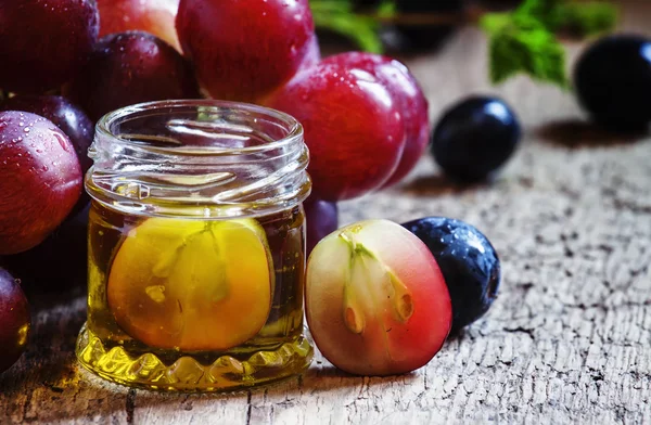 Healing grape seed oil in a glass jar — Stock Photo, Image