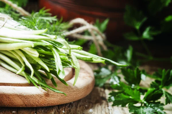 Ramson et des herbes sur une planche à découper en bois — Photo