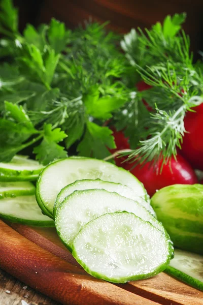 Sliced cucumber, vegetables and herbs — Stock Photo, Image