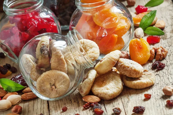 Delicious dried figs in a glass jars on old wooden table — Stock Photo, Image