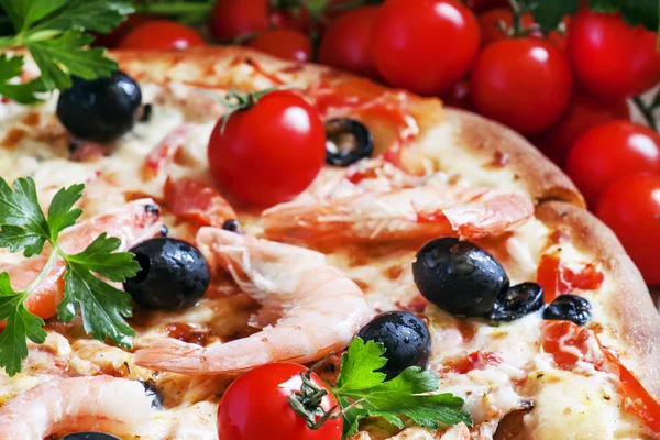 Pizza with seafood and black olives