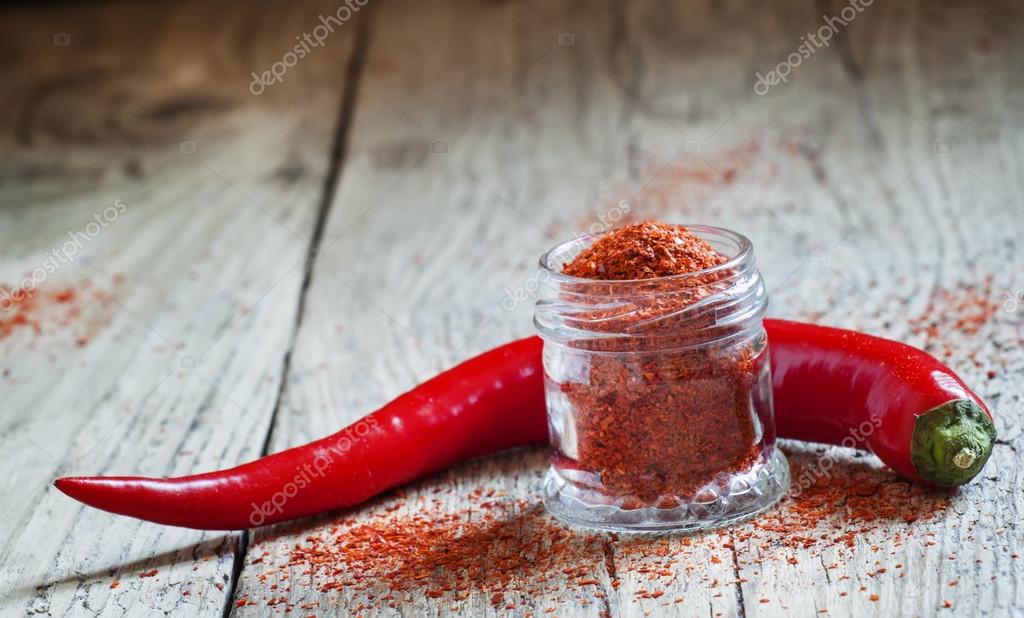 Ground hot red pepper in a glass jar Stock Photo by ©5PH 107428664