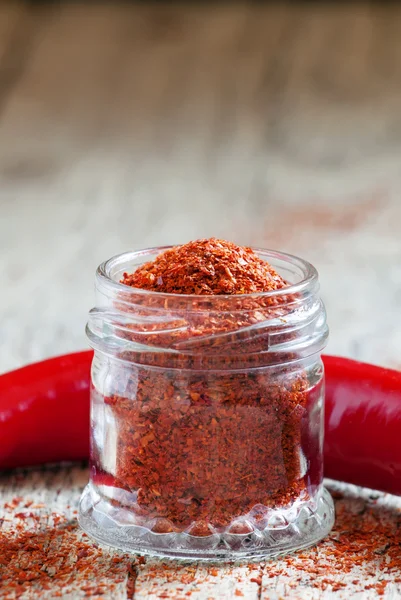 Ground hot red pepper in a glass jar — Stock fotografie