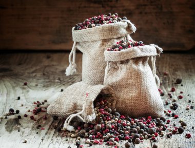 Siyah, pembe, beyaz biber ve çuval bezi torbalarda yenibahar