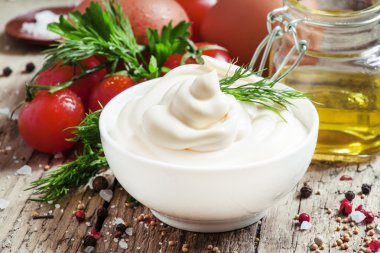 Homemade mayonnaise sauce in a white bowl clipart