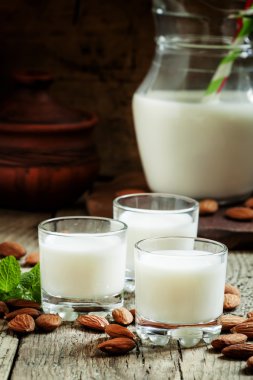 Badem ve süt, eski ahşap arka plan 