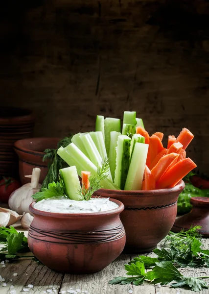 Fresh sticks carrots, celery, cucumber and white sauce with herbs