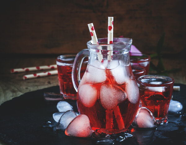 Red drink in a pitcher with ice in the shape of hearts