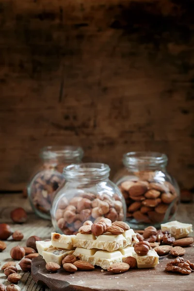 White chocolate with nuts assortment: almonds, hazelnuts, walnuts — Stock Photo, Image