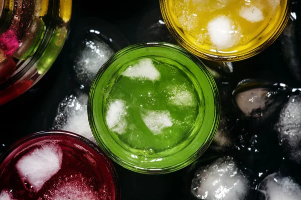 Blaue, rote, gelbe und grüne Cocktails mit Eis — Stockfoto