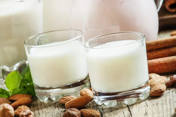 Frische Milchprodukte und Nüsse auf altem Holzgrund — Stockfoto