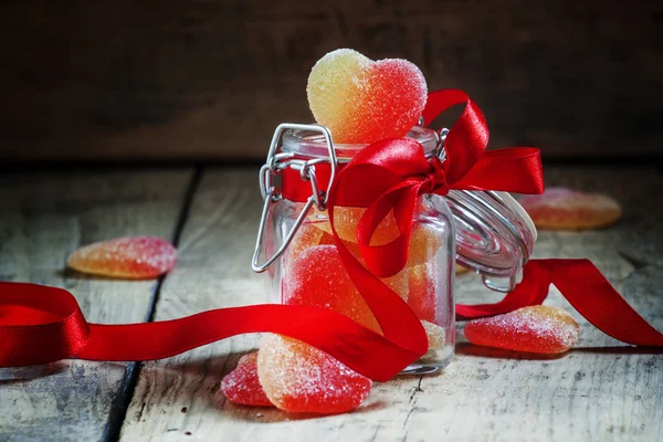 Fruit jelly hearts in a glass jar — Stock Photo, Image