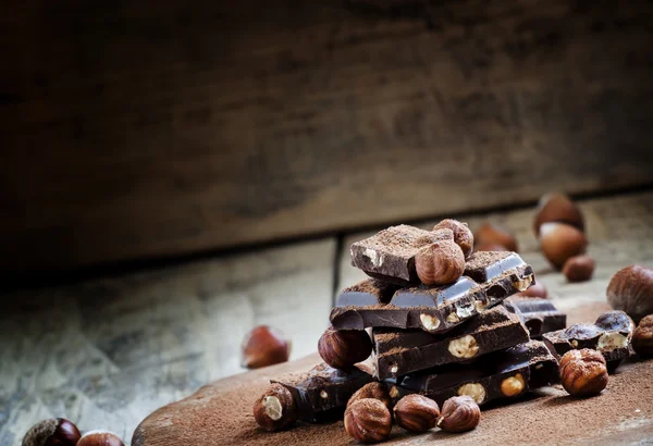 Dark chocolate with hazelnuts — Stock Photo, Image