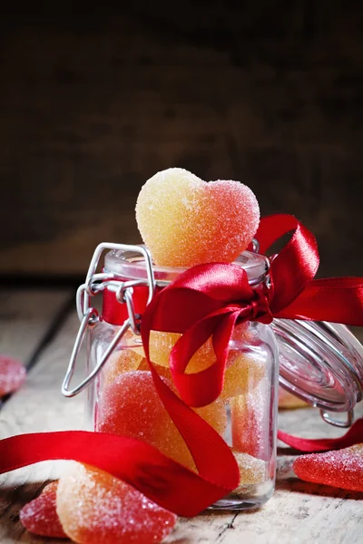 Fruit jelly hearts in a glass jar — Stock Photo, Image