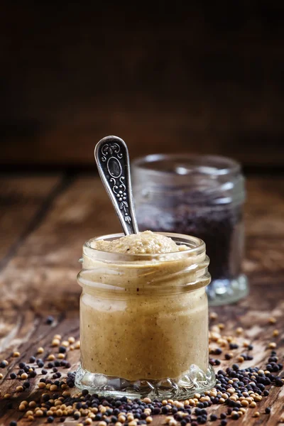 Mustard in a glass jar and seeds black and yellow — Stock Photo, Image