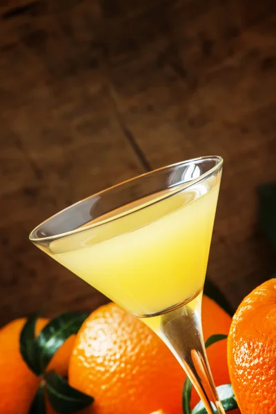 Yellow cocktail with orange juice in a martini glass — 스톡 사진