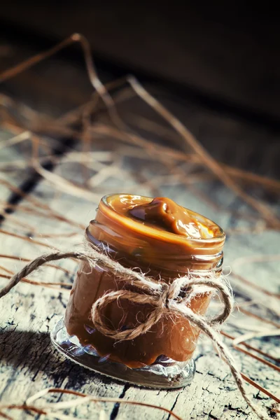 Soft homemade caramel in a glass jar — Stock Photo, Image