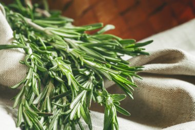 Fresh spicy fragrant rosemary on a gray napkin