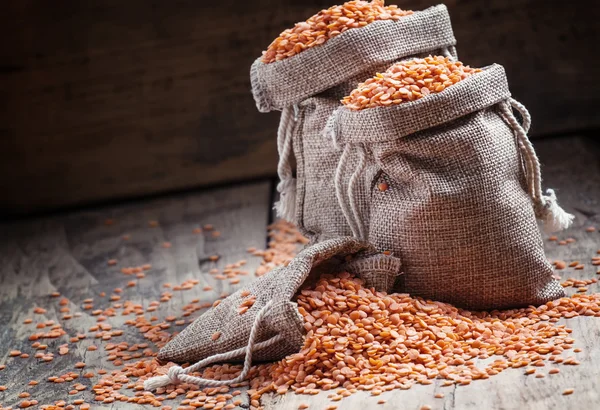 Red lentils in a burlap bags — Stock Photo, Image