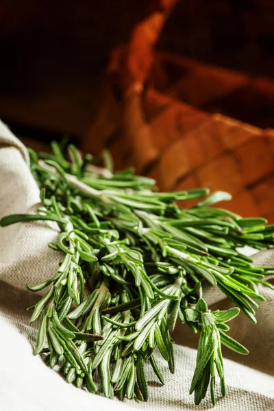 Fresh spicy fragrant rosemary on a gray napkin — Stockfoto