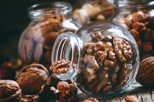 Walnuts in a glass jar, nut mix — Stock Photo, Image