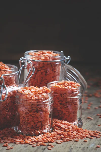 Useful red lentils in glass jars — Stock Photo, Image