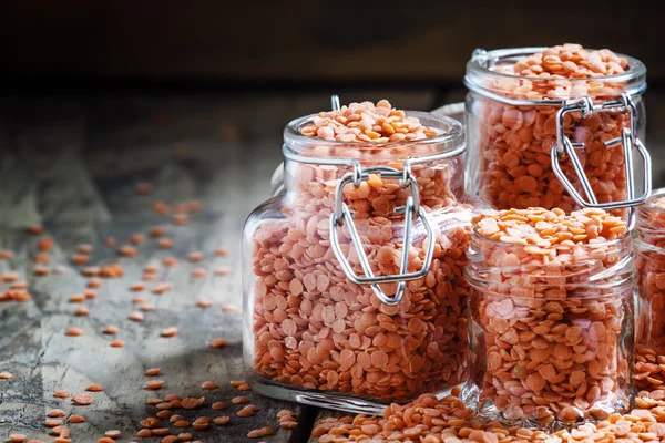 Useful red lentils in glass jars — Stock Photo, Image