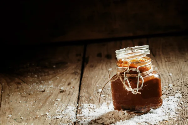 Salted caramel in a glass jar — Stock Photo, Image