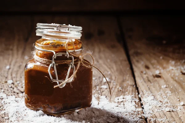 Salted caramel in a glass jar — Stock Photo, Image