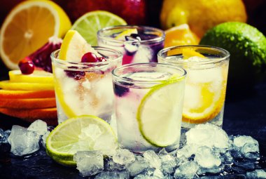 Chilled soft drinks with ice, citrus fruits and berries clipart