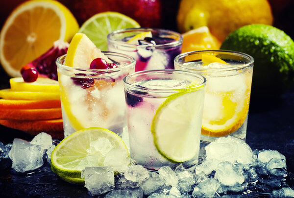 Chilled soft drinks with ice, citrus fruits and berries