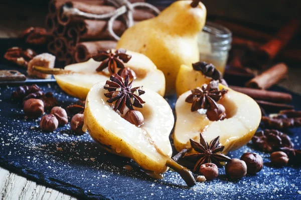 Ripe juicy pear with honey, spices and nuts — Stock Photo, Image