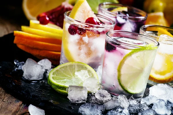 Chilled soft drinks with ice, citrus fruits and berries