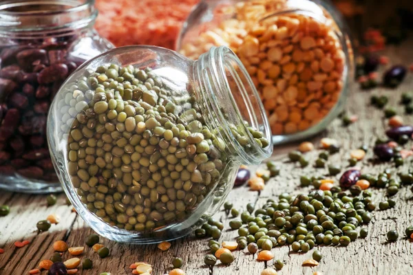 Green lentils in a glass jar, mix beans — Stock Photo, Image