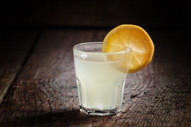 Single glass of vodka with lemon  clipart