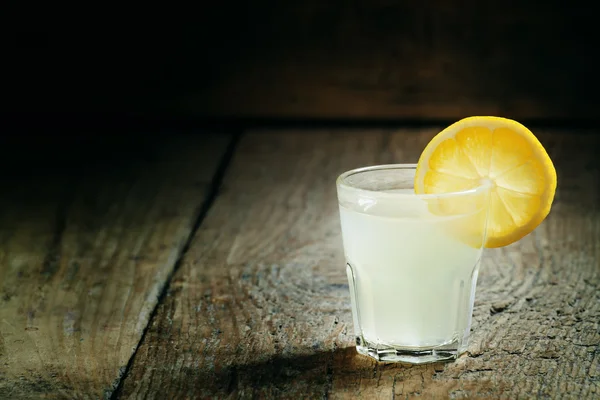 Single glass of vodka with lemon