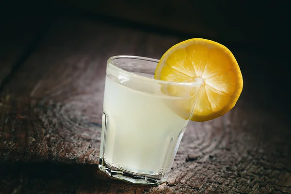 Single glass of vodka with lemon