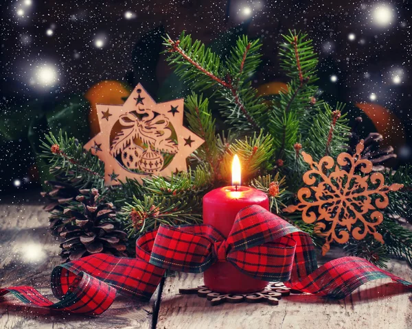 Christmas composition with burning red candle with plaid ribbon — Stock Photo, Image