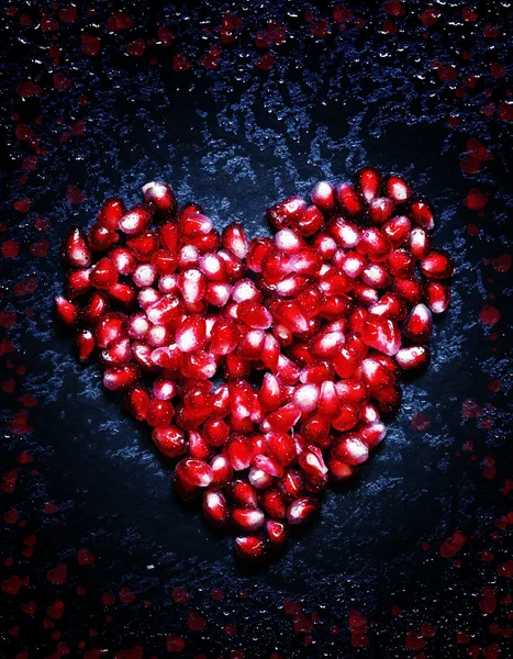 Composition for Valentine's Day with pomegranate seeds and paint — Stock Photo, Image