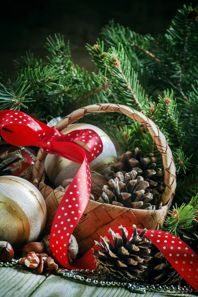 Wicker basket with Christmas balls and pine cones — Zdjęcie stockowe