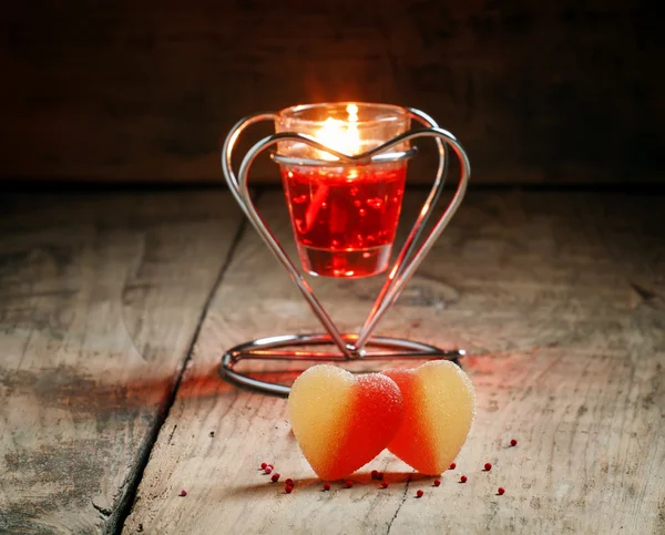 Valentine's Day composition with sweet hearts with burning red candle Royalty Free Stock Images