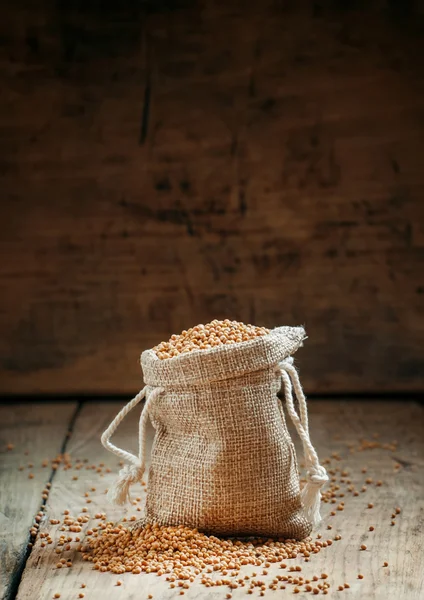 Grain mustard in a bag of sackcloth — Stock Photo, Image