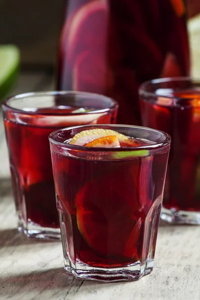 Sangria gyümölcs üvegek és egy régi fából készült háttér kancsó — Stock Fotó