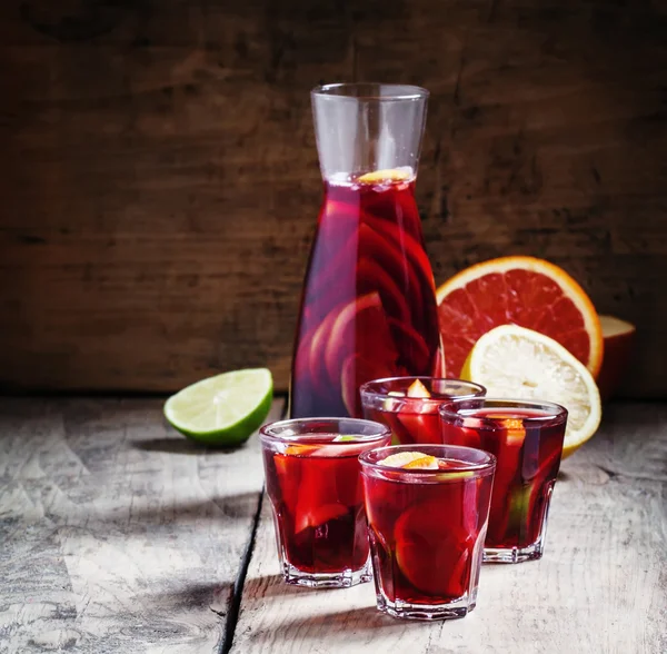 Sangria med frukt i glas och en kruka på gamla trä bakgrund — Stockfoto