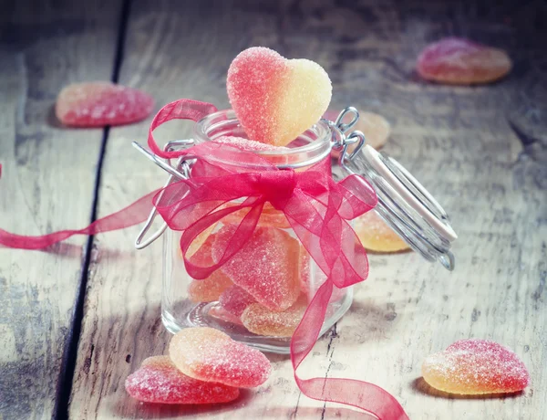 Fruit jelly hearts in a glass jar — Stock Photo, Image