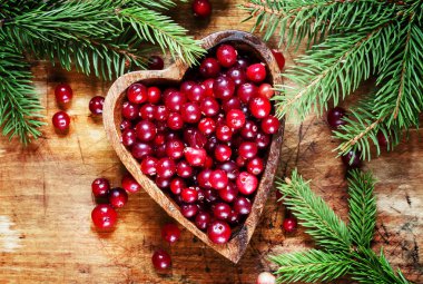 Fresh cranberries in heart shaped bowl 